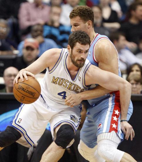 Minnesota Timberwolves forward Kevin Love (42) drives against Los Angeles Clippers forward Blake Griffin during the first half of their NBA basketball game in the Target Center in Minneapolis, March 5, 2012. Minnesota and Los Angeles are wearing throw back uniforms. Timberwolves beat Clippers 95-94.(Xinhua/Reuters Photo)