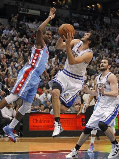 Minnesota Timberwolves guard Ricky Rubio (9) makes an off-balanced basket against Los Angeles Clippers guard Chris Paul (L) as Timberwolves forward Kevin Love (42) watches during the second half of their NBA basketball game in the Target Center in Minneapolis, March 5, 2012. Minnesota and Los Angeles are wearing throwback uniforms. Timberwolves beat Clippers 95-94.(Xinhua/Reuters Photo)
