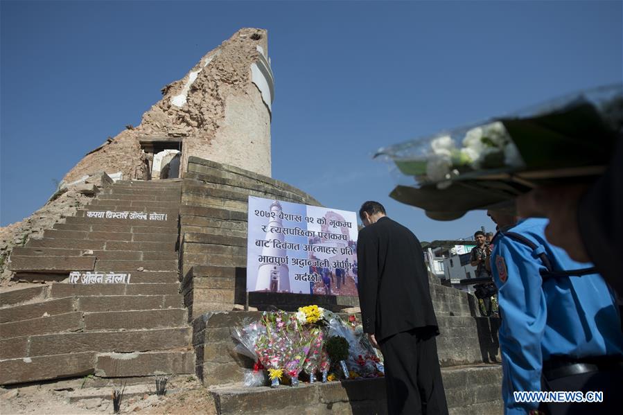 People mourn for the earthquake victims in front of the historical nine-storey tower Dharahara premise, which completely collapsed in the quake and killed over 100 people, in Kathmandu, capital of Nepal, on April 24, 2016. Nepalese Prime Minister KP Sharma Oli offered tributes to those who lost their lives in the April 25 earthquake last year and prayed for the peace of departed souls on Sunday, marking the first anniversary of the 7.9 magnitude devastating quake. (Xinhua/Cheong Kam Ka) 