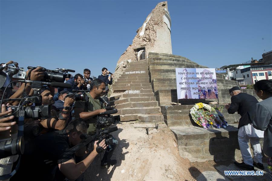 Nepalese Prime Minister KP Sharma Oli (2nd R) mourns for the earthquake victims in front of the historical nine-storey tower Dharahara premise, which completely collapsed in the quake and killed over 100 people, in Kathmandu, capital of Nepal, on April 24, 2016. Nepalese Prime Minister KP Sharma Oli offered tributes to those who lost their lives in the April 25 earthquake last year and prayed for the peace of departed souls on Sunday, marking the first anniversary of the 7.9 magnitude devastating quake. (Xinhua/Cheong Kam Ka)