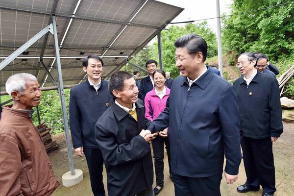 President Xi Jinping shakes hand with a villager at Dawan village in Jinzhai county, East China