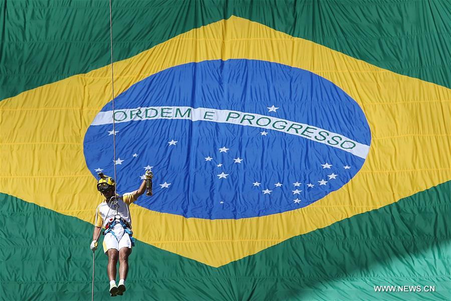 BRASILIA, May 4, 2016 (Xinhua) -- A firefighter carries the lamp of the Olympic flame to the Mane Garrincha National Stadium in Brasilia May 3, 2016. Brazil on Tuesday started the 95-day Olympic torch relay which will end at the Maracana Stadium in Rio de Janeiro in August for the 2016 Olympic Games opening ceremony. (Xinhua/Rahel Patrasso)