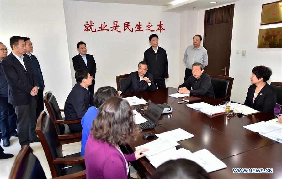  Chinese Premier Li Keqiang (5th R) visits the Ministry of Human Resources and Social Security in Beijing, capital of China, May 6, 2016. Li Keqiang inspected the Ministry of Human Resources and Social Security on May 6, urging for more efforts to support employment to guard against large-scale unemployment. (Xinhua/Li Tao)