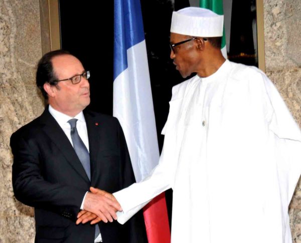 President Muhammadu Buhari(R) welcoming the visiting French President, Francois Hollande at the presidential villa Abuja on Saturday.