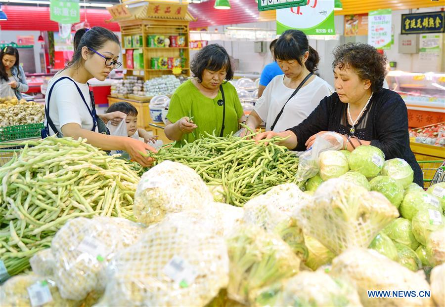 Citizens select vegetable at a supermarket in Xingtai, north China