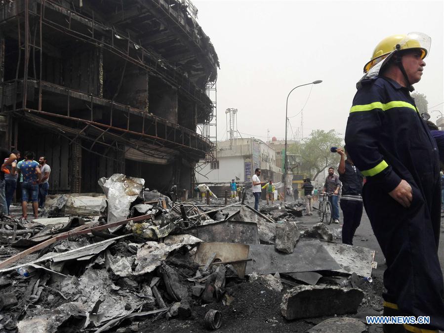 BAGHDAD, July 3, 2016 (Xinhua) -- A firefighter reacts at the car bomb attack site in Karrada-Dakhil district of southern Baghdad, Iraq, July 3, 2016. Death toll of the suicide car bomb attack at a crowded commercial area in the Iraqi capital of Baghdad early Sunday has risen to 124, while 142 others were wounded, an Interior Ministry source said. The Islamic State group on Sunday claimed responsibility for the attack. (Xinhua/Khalil Dawood) 