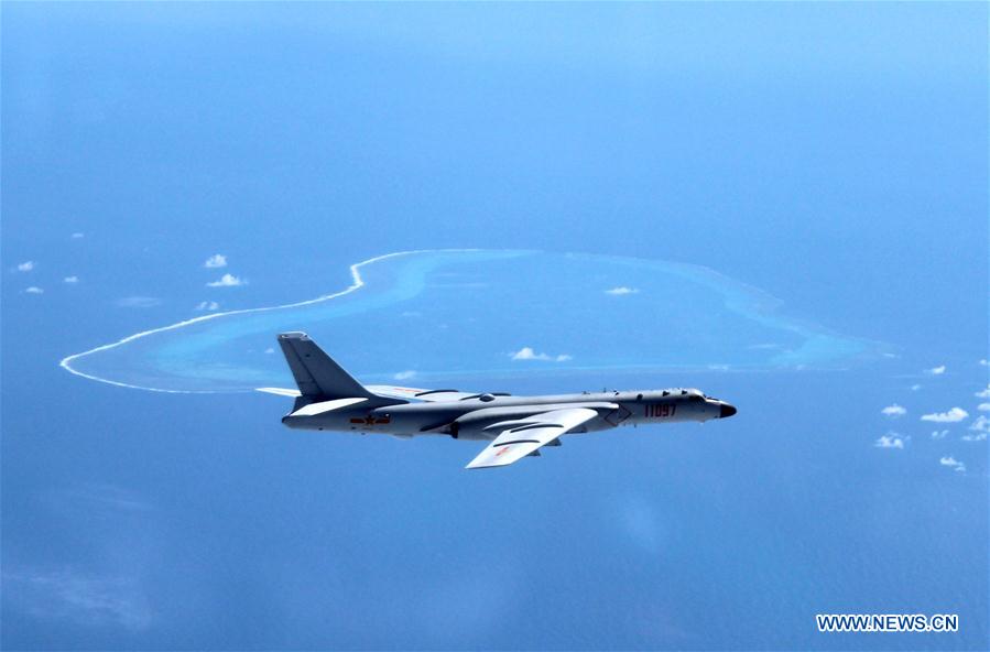 Undated photo shows a Chinese H-6K bomber patrolling islands and reefs including Huangyan Dao in the South China Sea. The People