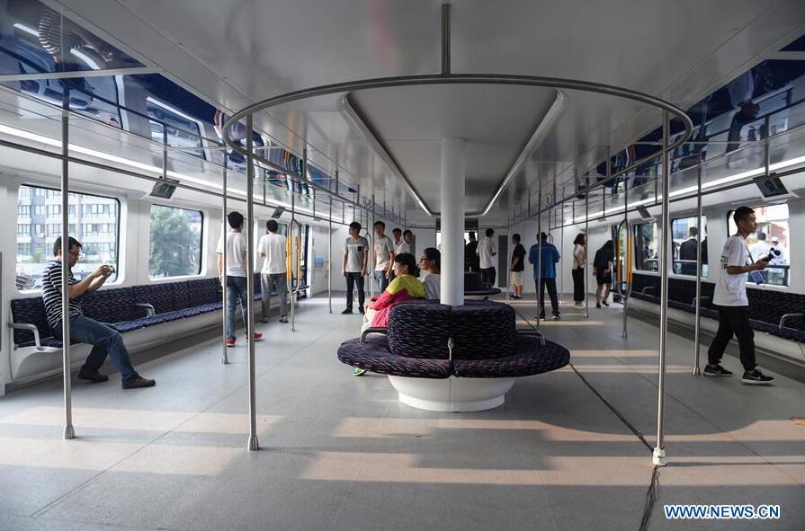 People experience in the compartment of a Transit Elevated Bus (TEB) which is on road test in Qinhuangdao, north China