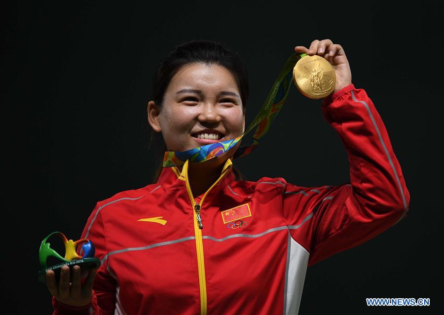 Zhang Mengxue of China shows the gold medal at the awarding ceremony of the Women