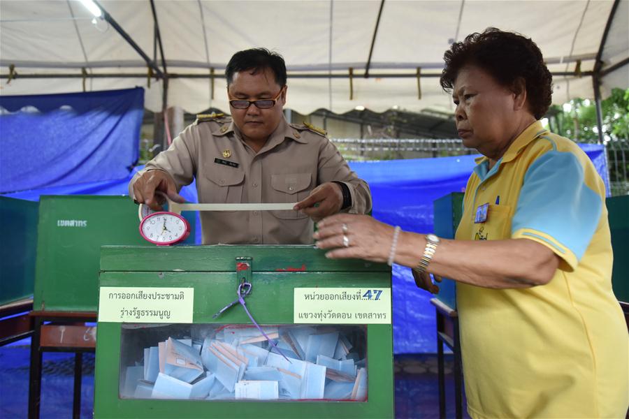 Staff members seal a ballot box at a polling station when Thailand