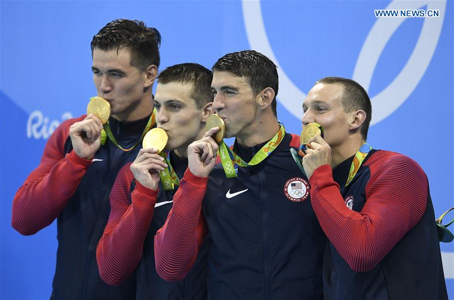 Swimmers from the United States of America attend the awarding ceremony of the swimming final of men