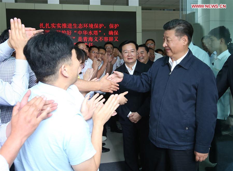Chinese President Xi Jinping (R, front) visits the provincial ecological environmental monitoring center in northwest China