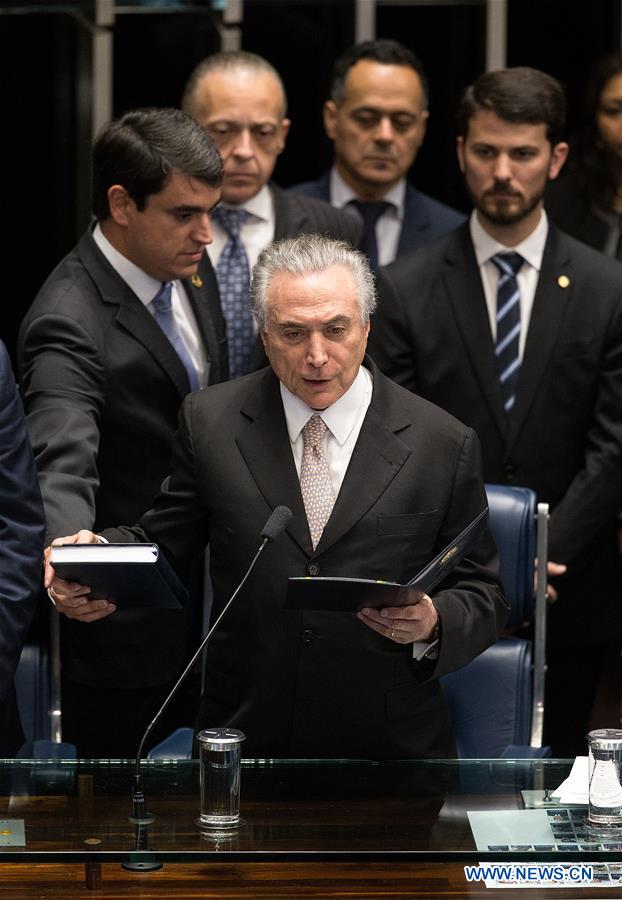 Michel Temer (front) takes oath at the senate in Brasilia, Brazil, Aug. 31, 2016. Temer was sworn in as the new president of Brazil on Wednesday afternoon, after Dilma Rousseff was stripped of the presidency by the Senate in an impeachment trial. (Xinhua/Li Ming)