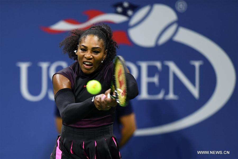 Serena Williams of the United States returns a ball to Simona Halep of Romania during the women