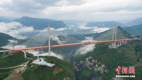 Work to connect the main part of the highest bridge in the world wrapped up on Saturday in southwest China