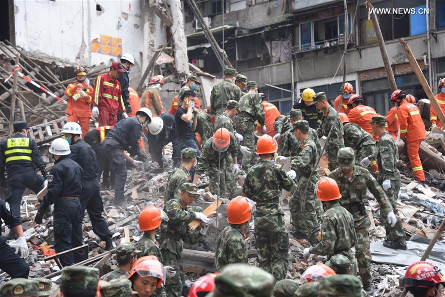 Rescuers work at the accident site after buildings collapsed in Wenzhou City, east China