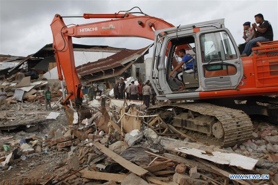 An excavator of Search and Rescue (SAR) team works on the debris in quake-hit Pidie Jaya district, Aceh, Indonesia, Dec. 7, 2016. At least 97 people have been killed and over 600 others suffered from wounds after a powerful and shallow underland quake hit western Indonesia