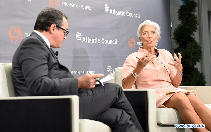 International Monetary Fund (IMF) Managing Director Christine Lagarde (R) speaks on 