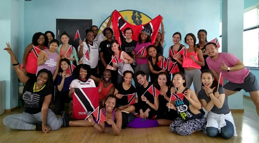 With Trinidad and Tobago’s flag in hand, participants of Soca Zumba strike a pose. The event was held on February 25 at Caravan in Jianguomen.