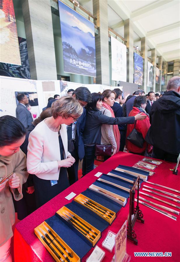 People visit the exhibition "Beautiful China, Picturesque Zhejiang" in Geneva, Switzerland, on April 19, 2017. The exhibition was held here on Wednesday as part of the activities marking the 2017 United Nations Chinese Language Day. (Xinhua/Xu Jinquan) 