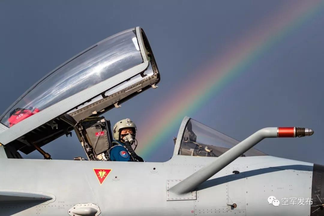 7月21日,歼-10A战机飞行员打开舱盖,一道彩虹探进了座舱