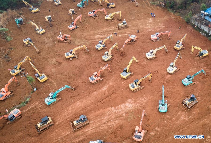 Aerial photo taken on Jan. 24, 2020 shows mechanical equipment working at the contruction site of a special hospital in the Caidian District of western suburb of Wuhan, central China