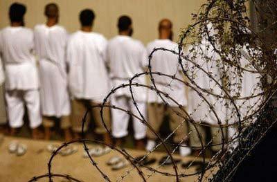 Detainees&nbsp;stand&nbsp;during&nbsp;an&nbsp;early&nbsp;morning&nbsp;Islamic&nbsp;prayer&nbsp;at&nbsp;the&nbsp;US&nbsp;military&nbsp;prison&nbsp;for&nbsp;"enemy&nbsp;combatants,"&nbsp;in&nbsp;October&nbsp;2009,&nbsp;in&nbsp;Guantanamo&nbsp;Bay,&nbsp;Cuba.&nbsp;President&nbsp;Barack&nbsp;Obama&nbsp;admitted&nbsp;for&nbsp;the&nbsp;first&nbsp;time&nbsp;on&nbsp;Wednesday&nbsp;that&nbsp;the&nbsp;United&nbsp;States&nbsp;would&nbsp;miss&nbsp;the&nbsp;January&nbsp;2010&nbsp;deadline&nbsp;he&nbsp;set&nbsp;for&nbsp;closing&nbsp;the&nbsp;"war&nbsp;on&nbsp;terror"&nbsp;prison&nbsp;at&nbsp;Guantanamo&nbsp;Bay,&nbsp;Cuba.&nbsp;(AFP/Getty&nbsp;Images/File/John&nbsp;Moore)&nbsp;