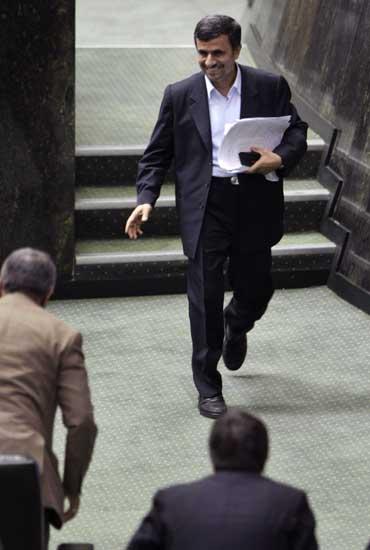 Iranian President Mahmoud Ahmadinejad, leaves the podium after answering questions in an open session in parliament in Tehran, Iran, Wednesday, March 14, 2012.