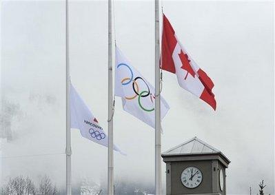 The Canadian, Olympic and Vancouver 2010 flags fly at half-staff in respect of luge athlete Nodar Kumaritashvili in Whistler, British Columbia, Saturday, Feb. 13, 2010. Kumaritashvili of Georgia crashed and died on Friday, during a men's singles luge training run at the Vancouver 2010 Winter Olympics.(AP Photo/Gero Breloer) 