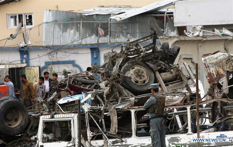 afghan security force members inspect the site of a deadly