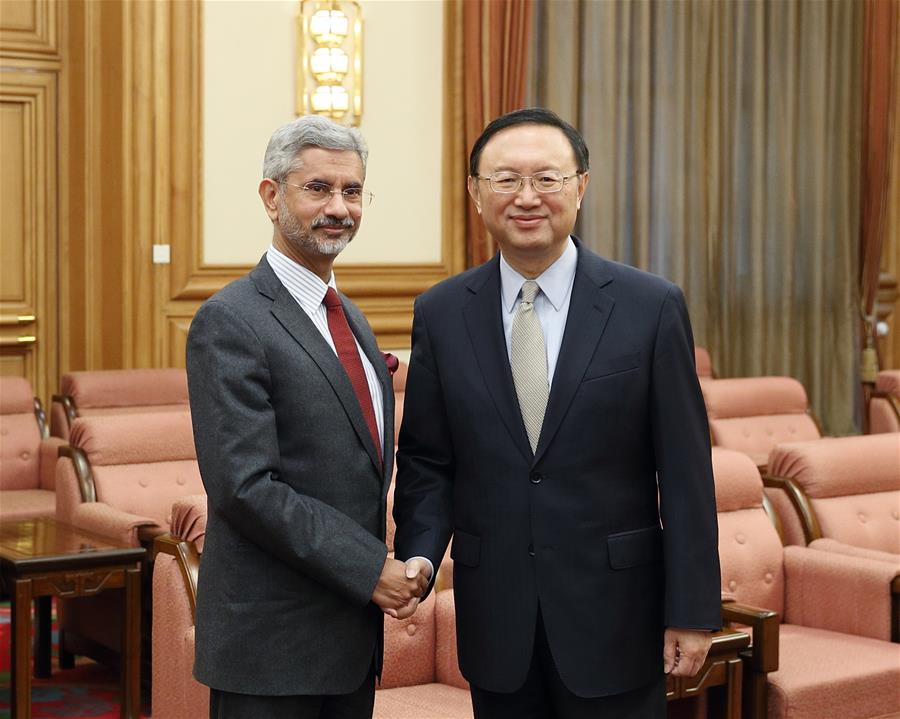 chinese state councilor yang jiechi (r) shakes hands with indian