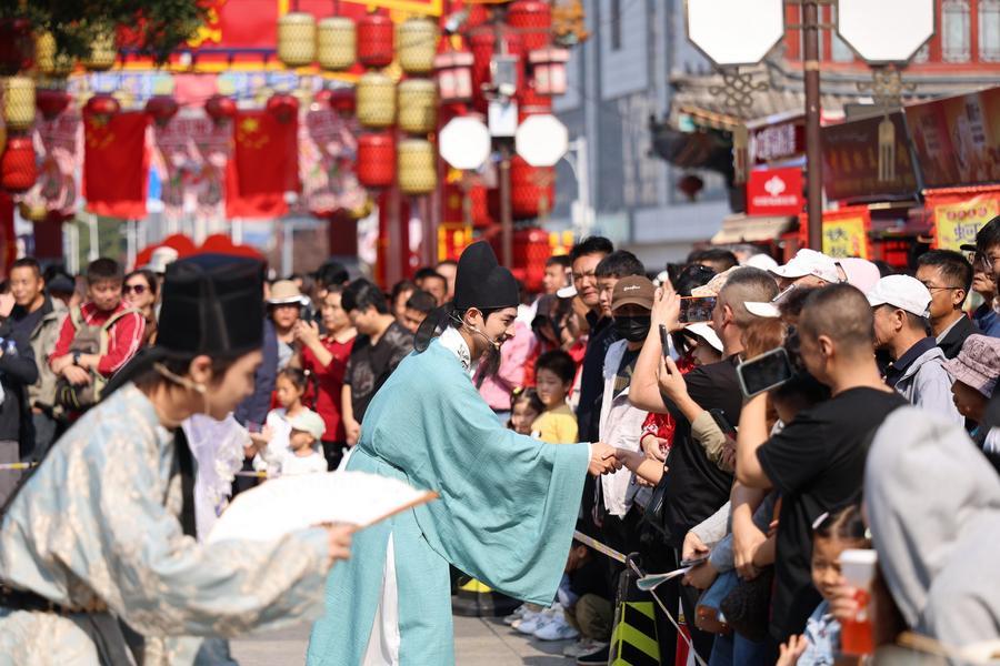 Tourists interacting with actors at Yangliuqing ancient town